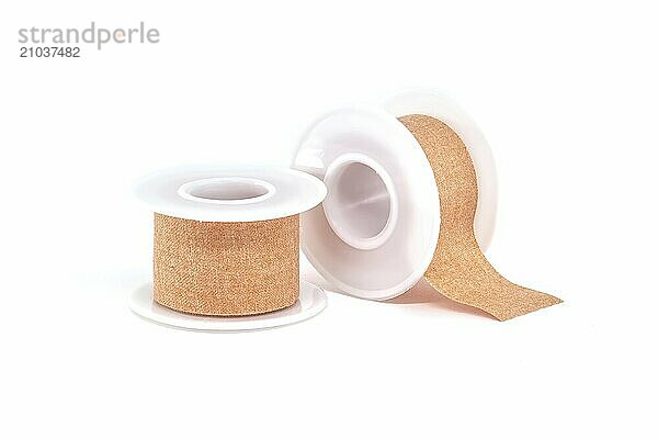 Two rolls of surgical adhesive plasters isolated on white background  medical supplies