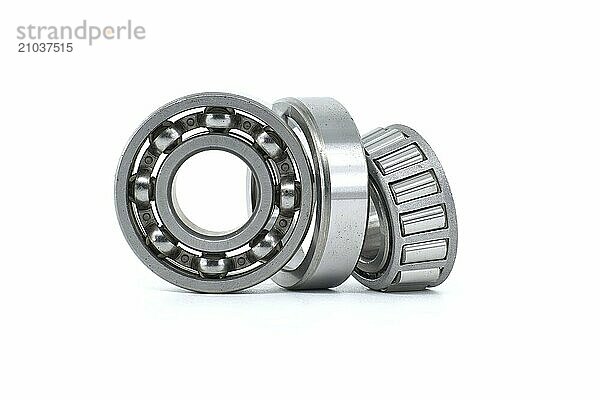 Ball bearing and tapered roller bearing isolated on white background