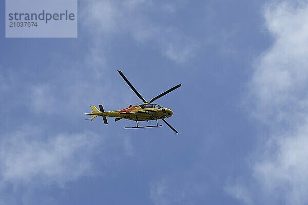 Agusta AW119 helicopter flying across a blue sky  England  United Kingdom  Europe