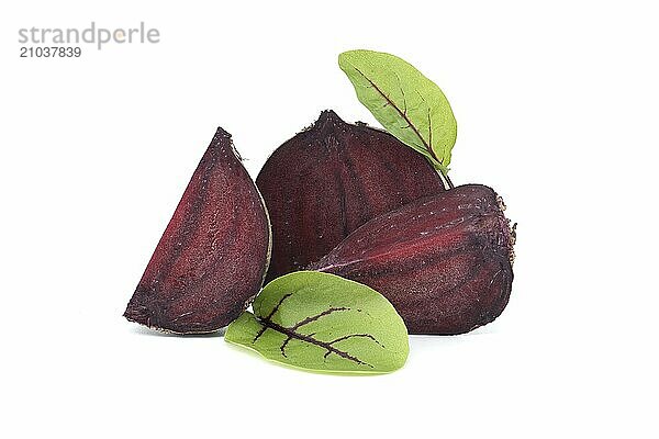 Slices of beetroot revealing their vibrant purple interiors complete with their fresh green leaves isolated on white background