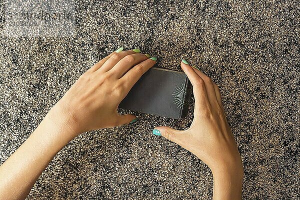 Top view of a client's hands cutting a tarot deck