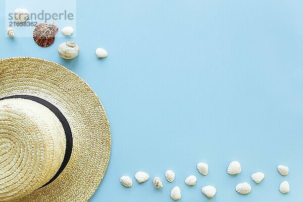 Travel or vacation concept. Hat with sea shells. Relaxation. Blue background.