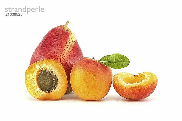 Whole and halved ripe apricots  multicolored pear isolated on a white background. Multivitamin and juicy rich fruits