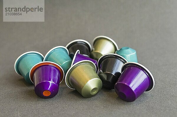 Beautiful colored coffee capsules on black background