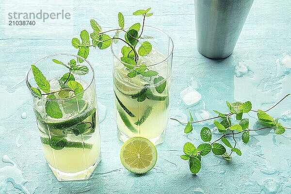 Mojito cocktail. Summer cold drink with lime  fresh mint leaves  and ice. Cool beverage on a blue background  Food photography  Food photography