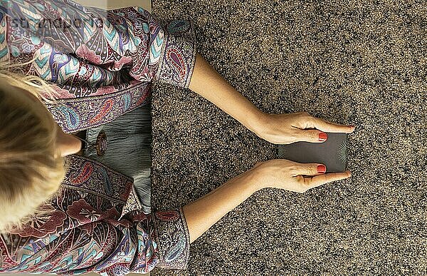 Top view of a tarot reader holding the deck of tarot cards