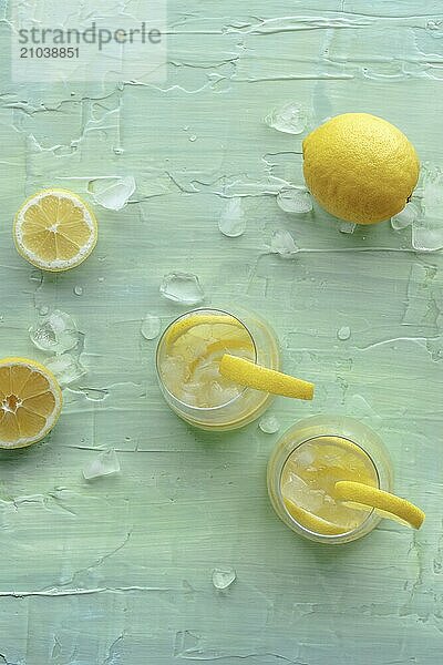 Lemonade. Lemon water drink with ice. Two glasses and fruits on a blue background. Detox beverage. Fresh homemade cocktail  Food photography  Food photography