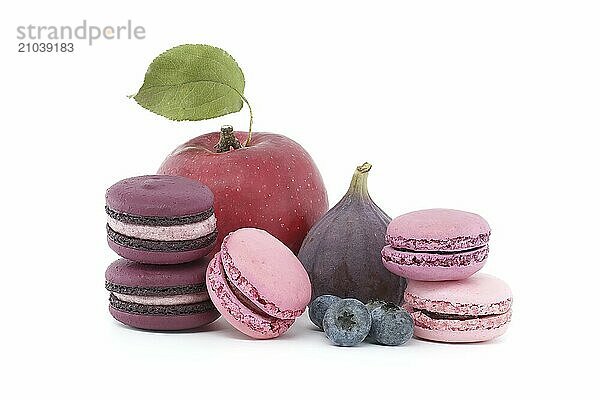 Vibrant scene of fruits and sweet meringue based macarons isolated on white background