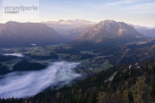 View from Mount Loser to Lake Altaussee  Altaussee  Bad Aussee  Tressenstein  Zinken  Sarstein  Dachstein mountains. Wafts of mist over the lake. In the morning at sunrise. Blue sky. Autumn. Altaussee  Bad Aussee  Ausseer Land  Totes Gebirge  Styria  Upper Austria  Austria  Europe