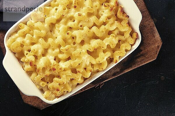 Macaroni and cheese pasta in a casserole  shot from above on a dark background  American dinner  Food photography  Food photography