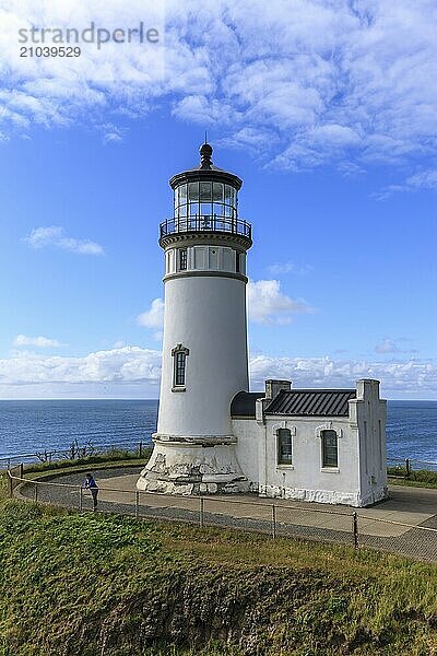 A female tourist stands by the North Head lighthouse in Ilwaco  Washington