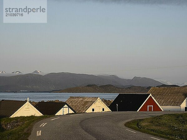 On the Norwegian island of Runde  a road leads past old boathouses