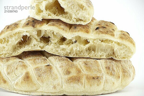 Pieces of pita flat-bread are stacked atop each other isolated on white background  typical fast food item  with the potential to be used as a snack