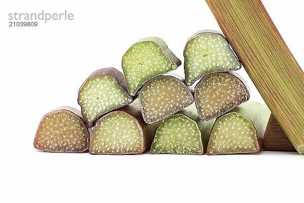 Variety of rhubarb stalks of varying colors from pale green to deep red isolated on white background  health benefits of eating rhubarb