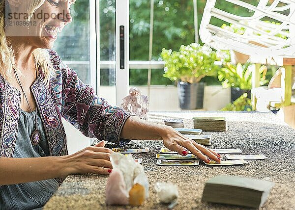 Side view of a tarot reader reading the cards