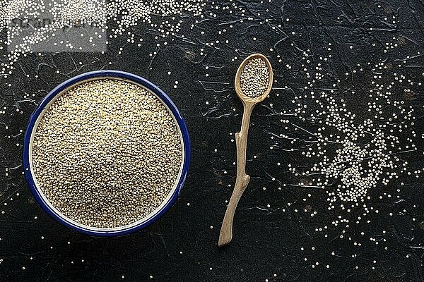 Quinoa in a bowl  healthy organic wood  uncooked  shot from the top on a black background with copy space  Food photography  Food photography