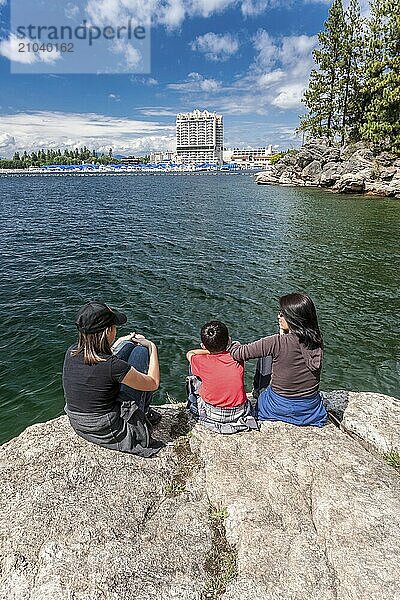 A mother and her two kids enjoying the view of Coeur d'Alene lake and the resort from Tubbs Hill