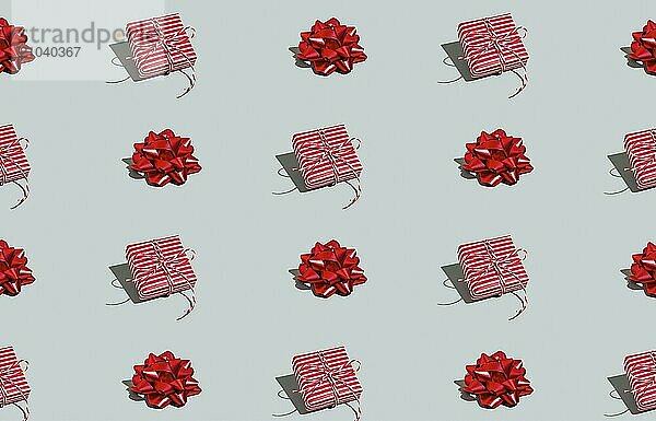 Gray green background pattern with Christmas  New Year symbol attribute objects and symbolic items concept. Pink little gift box present with ribbon  small red tied bow. Book cover  covering paper