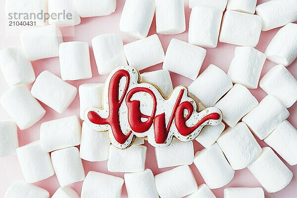 Gingerbread cookies love with white marshmallow. Valentine card. Pink background.