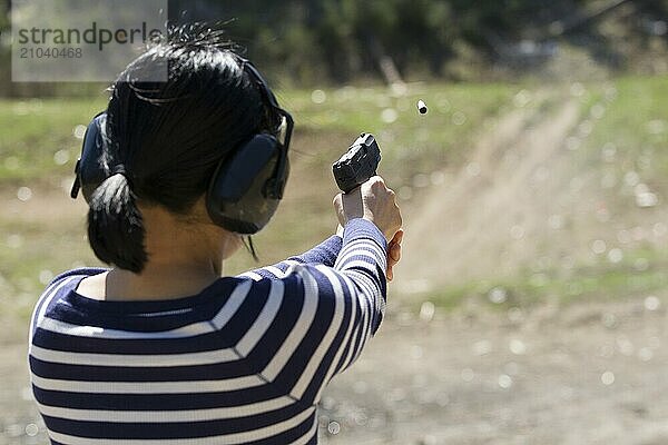 A woman safely praqctices shooting a pistol at a range in north Idaho