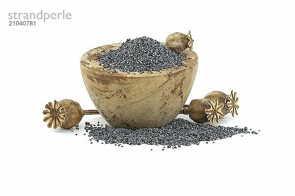 Poppy seeds in wooden bowl and seed pods isolated on white background  full depth of field