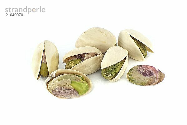 Pistachios in-shell and others peeled exposing the green nuts inside isolated on white background