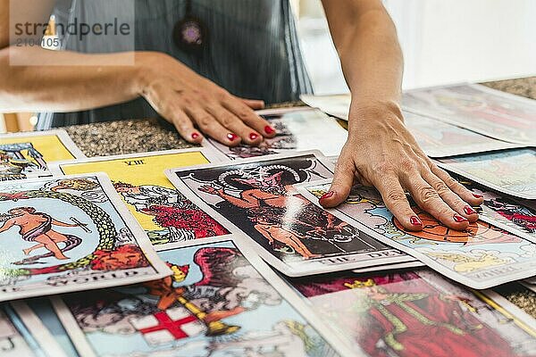 Tarot reader mixing the giant Tarot cards