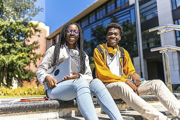 Low angle view portrait of two cool african american students in the university campus