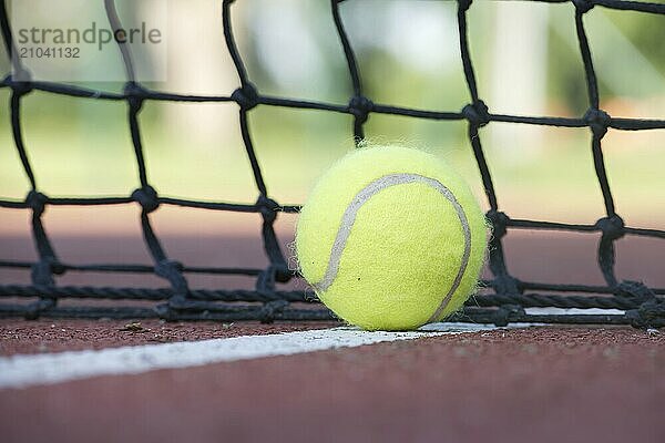 Tennis scene with black net  ball on white line in low angle view