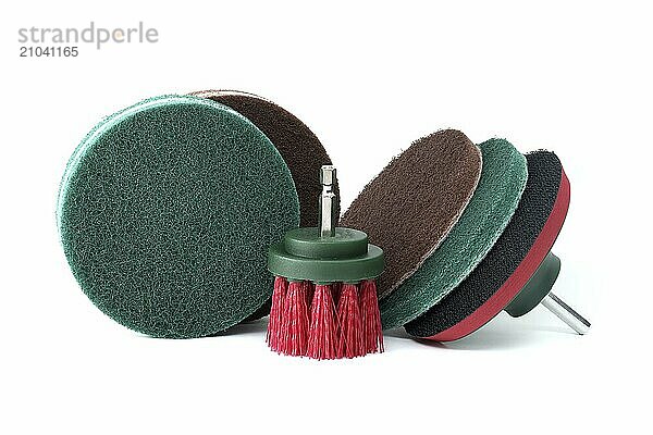 Hook and loop sanding pad and brush attachments vith an hexagonal shalf near round polishing pads with velour backing isolated on white background. Sanding  cleaning and polishing accessories