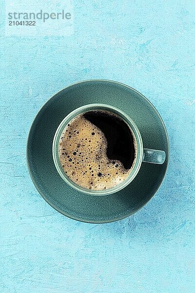 Coffee cup  top shot on a blue background  espresso drink on a turquoise table  a flat lay with copy space  Food photography  Food photography