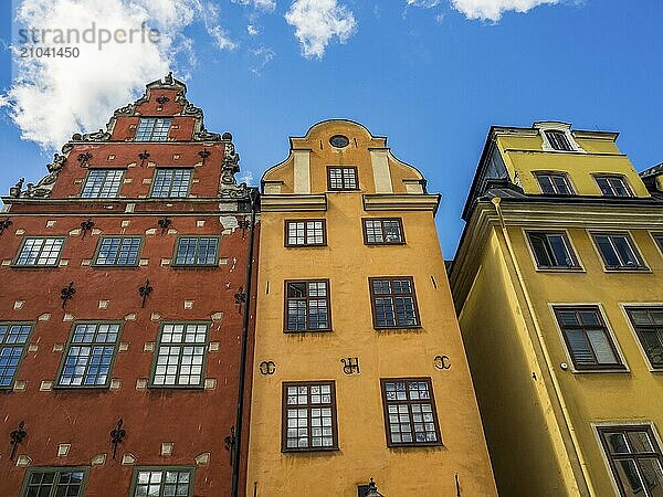 Three colourful houses in an old town under a blue sky  stockholm  baltic sea  sweden  scandinavia