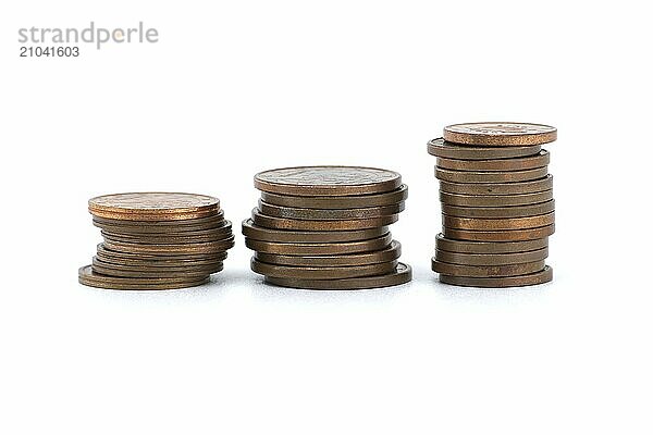 Stacks of coins ordered by size from largest to smallest and arranged from left to right isolated on white background