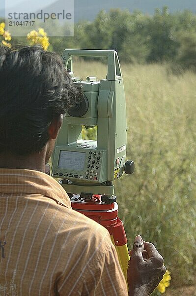 Men surveying land in Tamil Nadu  India  Asia