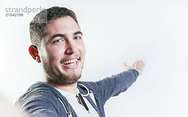 Happy young man welcoming you isolated. Portrait of smiling guy inviting to come