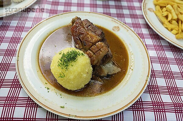 Fresh Schäuferle with dumplings served in a garden restaurant  Franconia  Bavaria  Germany  Europe