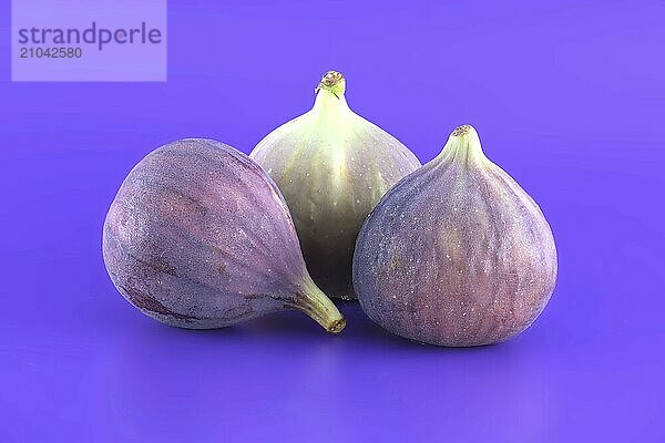 Pile of fresh figs over purple background. Full depth of field