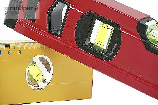 Red and yellow spirit level with a bubble indicator displayed against a white background