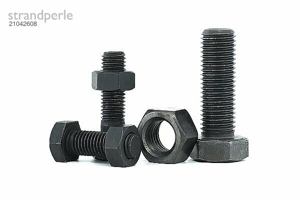 Orderly arrangement of dark-colored metal of hex bolts and nuts include long and shorter parts  placed against a clean  white background