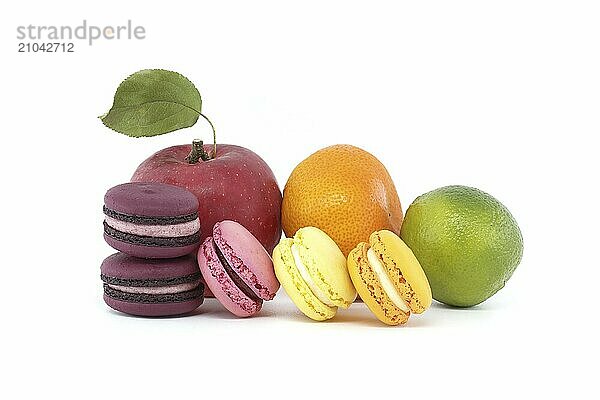 Vibrant assortment of macaroons and fruits isolated on white background. Full depth of field