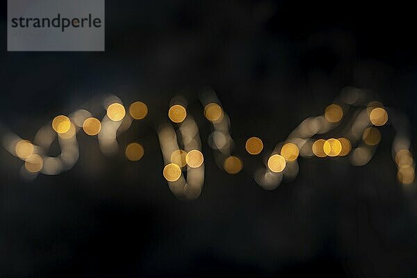 Golden fairy lights  string led garland  blurred  top shot with bokeh on a black background  Food photography