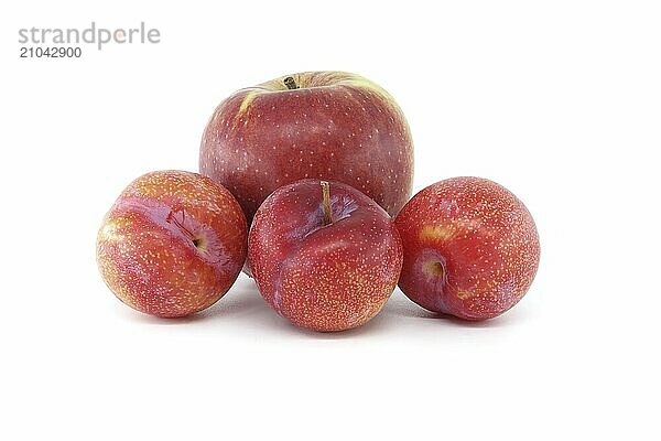 Crimson plums and red apple isolated on white background