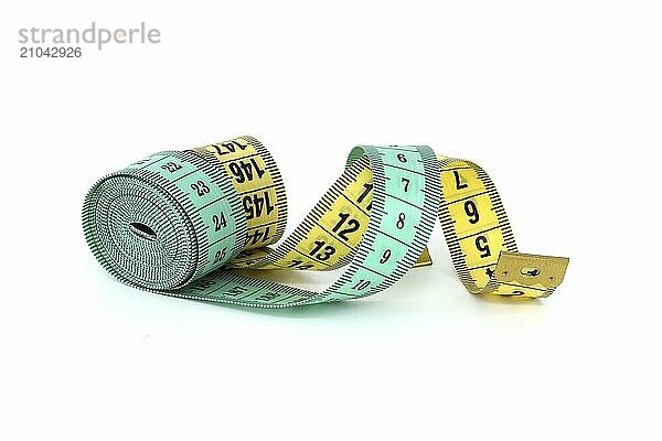 Spirals of green and yellow tape measure create a visual impression of motion  isolated white background