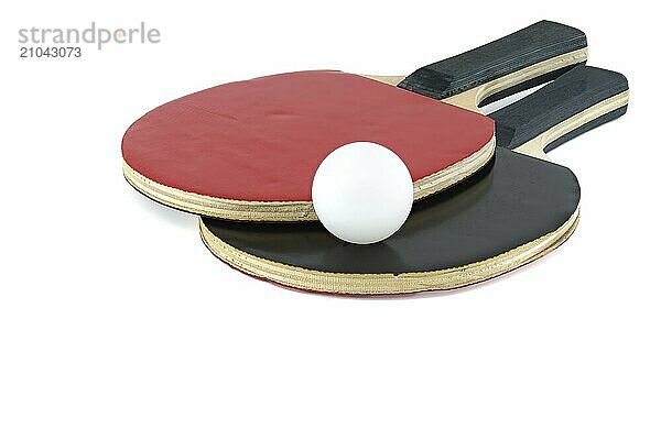 Pair of ping pong paddles and a ping pong ball isolated on white background  one rackets surface appearing in red and the other in black