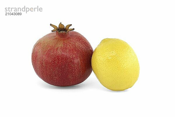 Fresh ripe pomegranate and whole yellow lemon isolated on white background