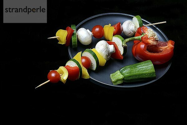 Colourful vegetable skewers on a plate  barbecue skewers