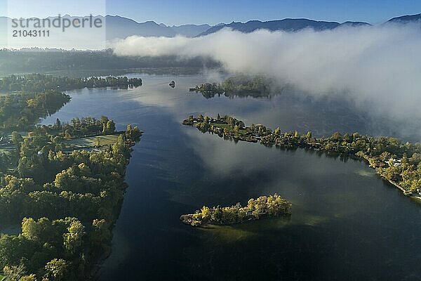 Aerial view of a lake in front of mountains in the morning light  fog  Staffelsee  view of the Bavarian Alps  Alpine foothills  Upper Bavaria  Bavaria  Germany  Europe