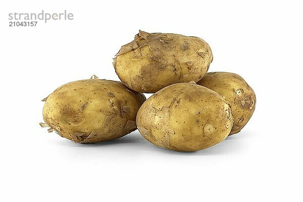 Group of fresh early potatoes  with a light brown skin and dark brown spots isolated on a white background