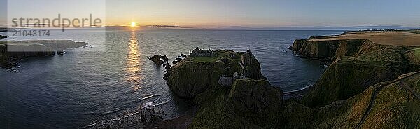 Dunnottar Castle  castle ruins at sunrise on the cliffs  drone shot  Stonehaven  Aberdeenshire  Scotland  Great Britain