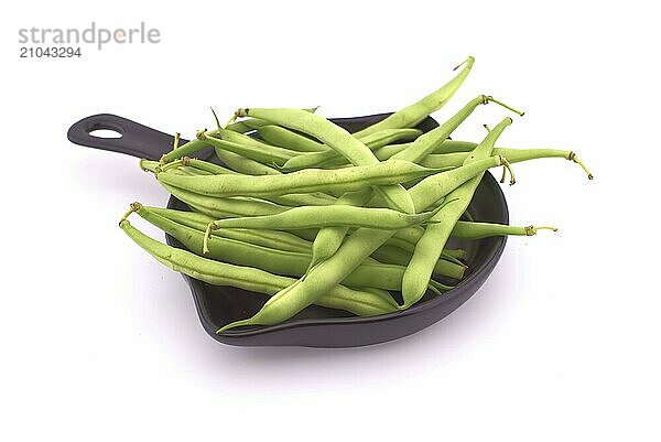 A handful of green beans in the cooking pan isolated on white background. Healthy  nutritious vegetarian food